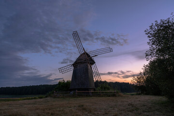 Plakat State museum-reserve of Alexander Pushkin «Mikhailovskoye». Beautiful russian landscape with an old windmill at sunset. July 2020.