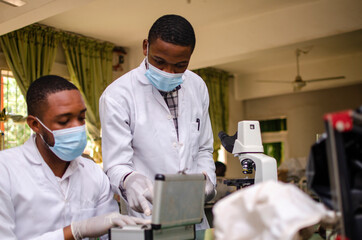 young black laboratory scientists carrying out a blood test for a vaccine
