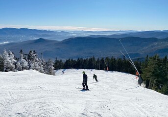 Skier on the slopes and scenic mountain view on background