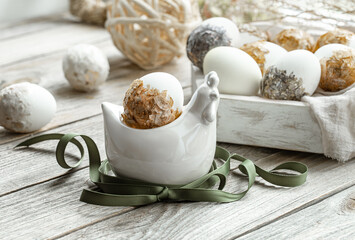 Spring easter composition with eggs and plants on wooden surface close up.
