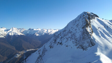 Fototapeta premium Snowy mountains on a bright blue day. Krasnaya polyana, Krasnodarsky krai, Russia 