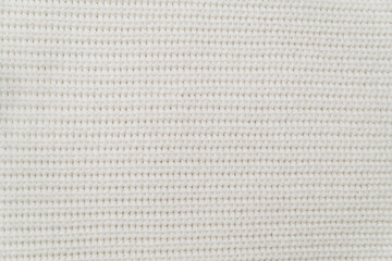 the background of a white knit fabric copy space. soft knitwear structure