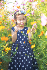 Portrait of a happy asian girl in flower fields, Outdoor