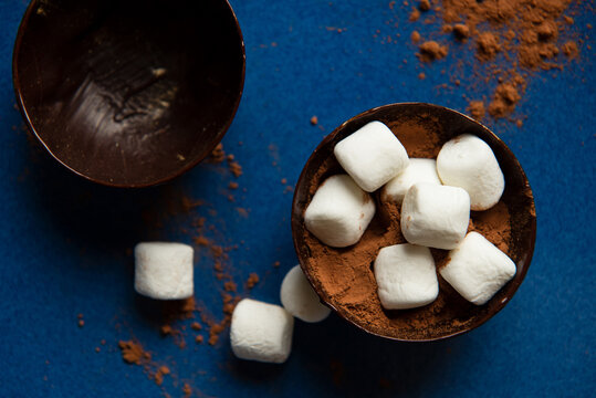 Partially filled chocolate shells for hot chocolate bombs.