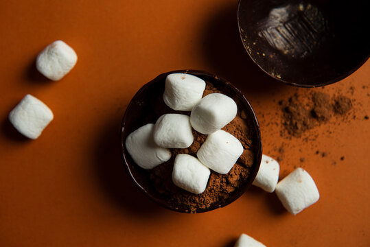 Partially filled chocolate shells for hot chocolate bombs.