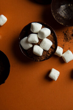 Partially filled chocolate shells for hot chocolate bombs.