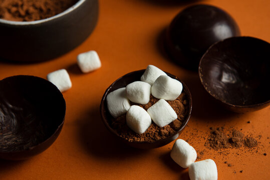 Partially filled chocolate shells for hot chocolate bombs.