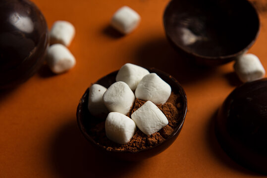 Partially filled chocolate shells for hot chocolate bombs.