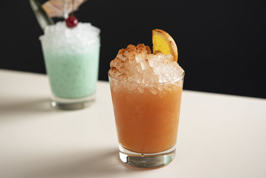 Pink tiki drink on pebble ice
