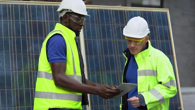 African american technician and senior engineer manager discussion and checking Solar Cell  panels . team Repair and maintenance  photovoltaic
