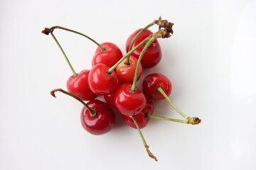 Obraz na płótnie Canvas Close-up Of Juicy Cherries Against White Background