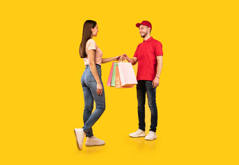 Delivery Courier Man Giving Shopping Bags To Lady, Yellow Background