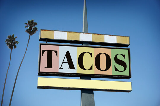 Aged and worn vintage tacos sign