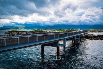 Fototapeta na wymiar Hulvagen Bridge near Atlantic Ocean Road, passing through small islands in Norwegian Sea and is part of National Tourist Routes.