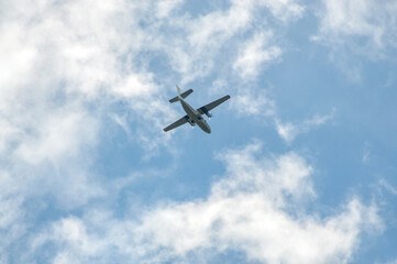 Fototapeta na wymiar the plane flies in the cloudy sky