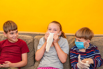 Surprised children look at the girl as she inflates the medical mitten.