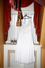 Wedding dress and shoes in the hotel room