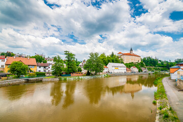 Naklejka na ściany i meble Panoramic view of castle above river in Ledec nad Sazavou. Sazava river is famous target for kayaking. Summer weather with dramatic clouds. Czech Republic.