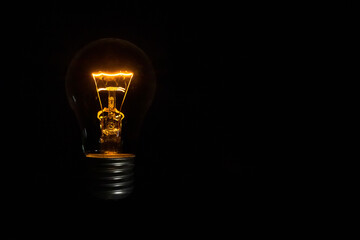 incandescent light bulb on black background