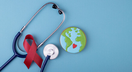 red ribbon symbol of the fight against AIDS on a blue background