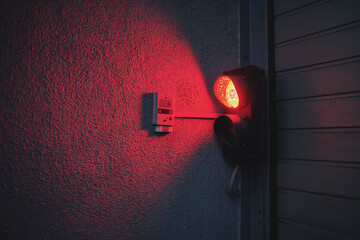 Red traffic light on the wall.