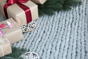 Fototapeta na wymiar Gift boxes with ribbons on a knitted background. Congratulations on the holidays. Love concept.