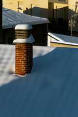 Snowed roofs at sunrise, after a blizzard