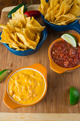 Cheese dip. Queso dip. Melted cheeses mixed with spices and hot sauce. Served with homemade tortilla chips avocado and meat.  Traditional classic Tex-Mex or Mexican restaurant appetizer favorite