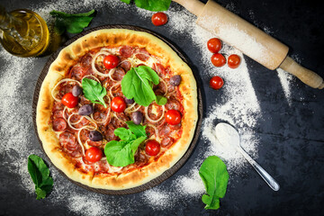 Traditional Brazilian pizza, vegetables, ingredients on a dark aged wooden background. Space for text.