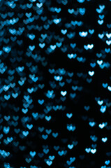 Color Bokeh on a dark background with hearts for use in graphic design