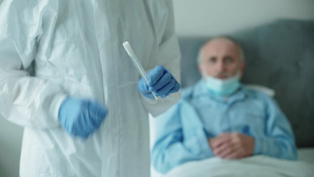 Biologist putting swab in test tube, covid-19 analysis, pcr testing at home