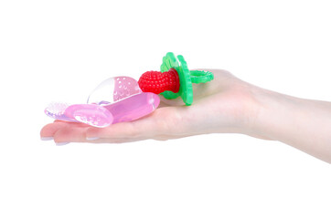 Teether massager raspberry and banana in hand on white background isolation