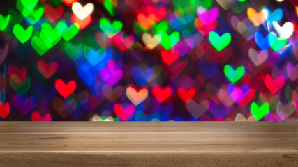 image of wooden table in front of abstract blurred background of heart bokeh lights