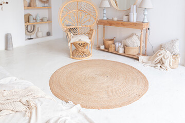Cozy interior of a bright Balinese-style apartment with white walls, bamboo chair, big white sofa and decorations © 4595886