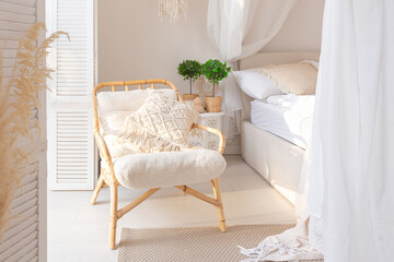 Cozy interior of a bright Balinese-style apartment with white walls, bamboo furniture. bed room with night lights, bed with balanchin and large windows