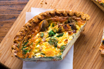 Quiche. Farm fresh eggs mixed with spinach, bacon, ham, sausage, cheese, vegetables poured in a pie crust and baked. Classic American restaurant or French Bistro breakfast or brunch favorite.