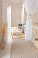 Cozy interior of a bright Balinese-style apartment with white walls, bamboo furniture. bed room with night lights, bed with balanchin and large windows © 4595886