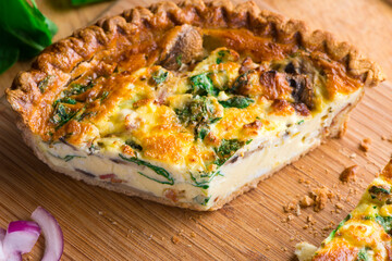 Quiche. Farm fresh eggs mixed with spinach, bacon, ham, sausage, cheese, vegetables poured in a pie crust and baked. Classic American restaurant or French Bistro breakfast or brunch favorite.