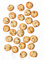 Butter cookies with dried cranberries and peanuts on a light background, top view