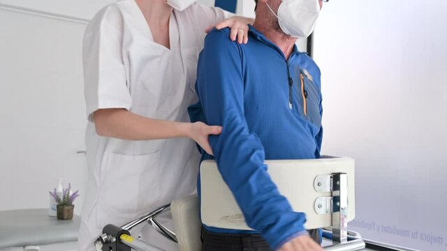 Physiotherapist assisting a patient with Amyotrophic Lateral Sclerosis. High quality 4k footage.