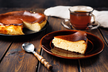 A piece of delicious basque burnt cheesecake with cup of tea