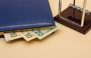 Newton's cradle and banknotes of the American dollars