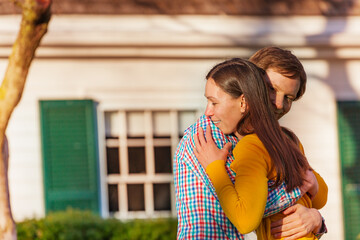 Young lovely couple hug outside in the park close portrait