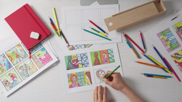 An illustrator artist draws a color storyboard on paper. Sketches for comics.