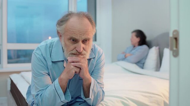Sad aged man sitting on bed, men's health, marriage crisis, misunderstanding