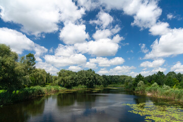 Daytime landscape, river and clouds on a sunny day