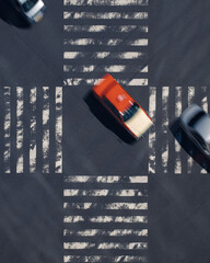vertical photo of a blurry orange taxi at a busy Japan  Tokyo street at a zebra crossing taken from above.