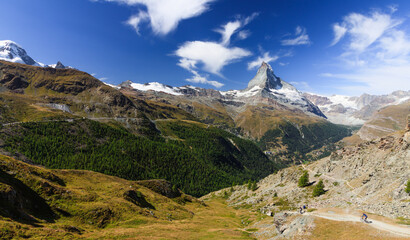 Matterhorn view with shining sun on a good summer day and clouds