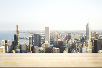 Blank wooden table top with beautiful Chicago skyline at daytime on background, mockup