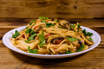 Pasta with mushrooms and tomato sauce in a plate